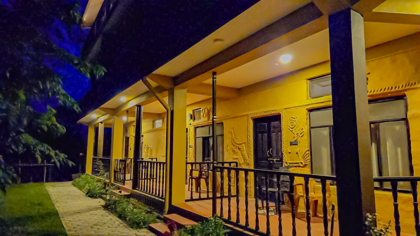 view of babaioutback room at night with outdoor lighting